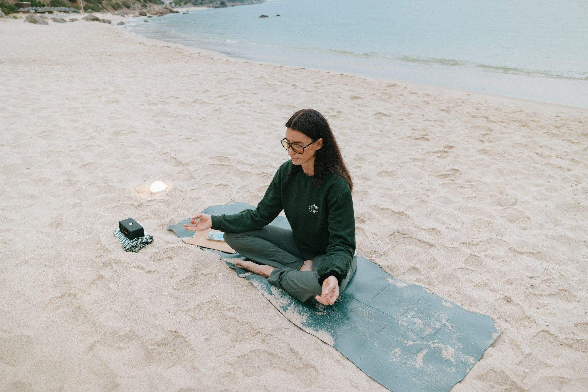 Lisa Wuerden meditating on the beach during the September residency (photo credits Atlas Cove)